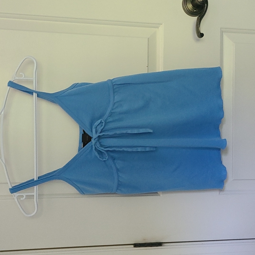 2/$25 Pretty sky-blue flowy top. Xsmall in New condition.